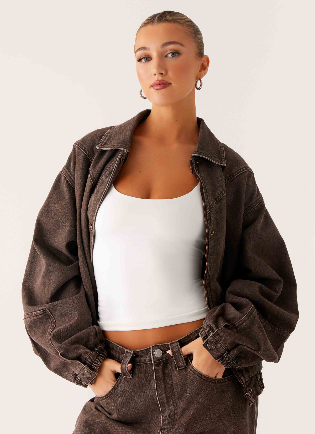 Women's brown washed denim bomber jacket with collar and cropped fit