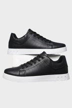 Men's low-top lace-up trainers with panelled uppers and contrasting flat soles