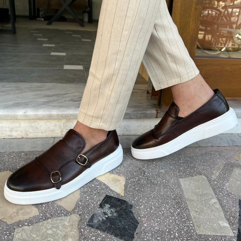 Men's double monk strap slip-on loafers shown in black and brown with white soles