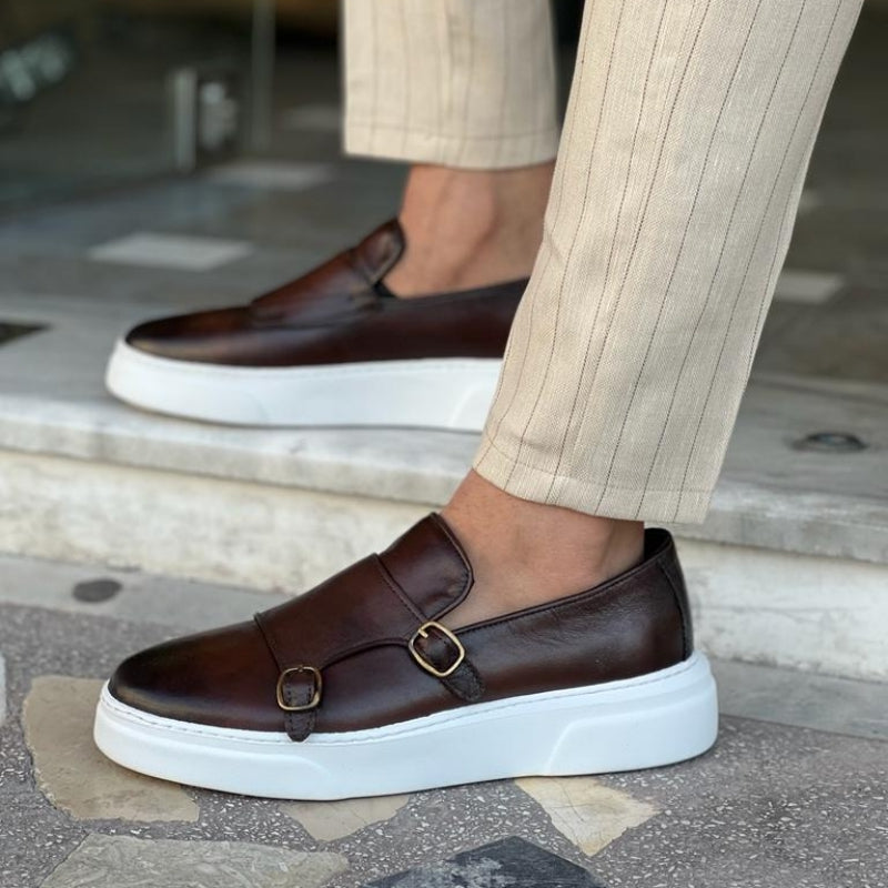 Men's double monk strap slip-on loafers shown in black and brown with white soles