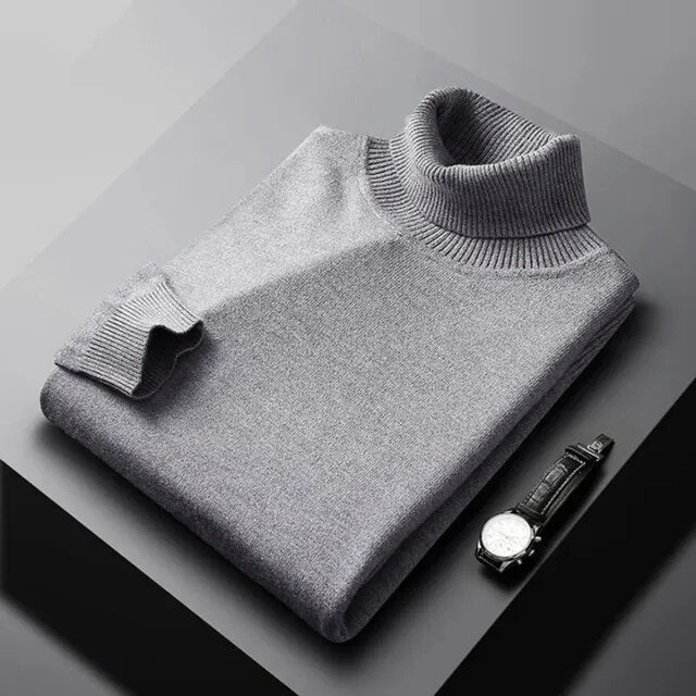 Men's plain ribbed turtleneck jumper folded on a surface