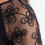 Women's black knee-length dress with long sheer floral embroidered sleeves
