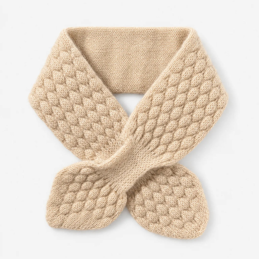 Textured knitted bowknot neckerchief scarf worn over a jumper
