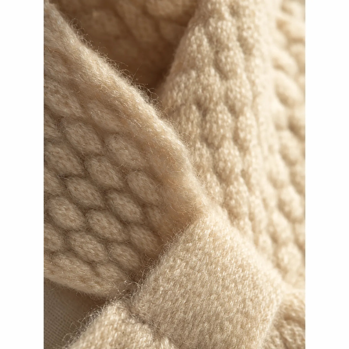 Textured knitted bowknot neckerchief scarf worn over a jumper