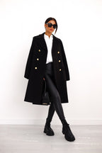 Women's long double-breasted coat with notched lapels and flap pockets