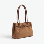 Structured women's tote bag with dual handles and front belt buckle detail