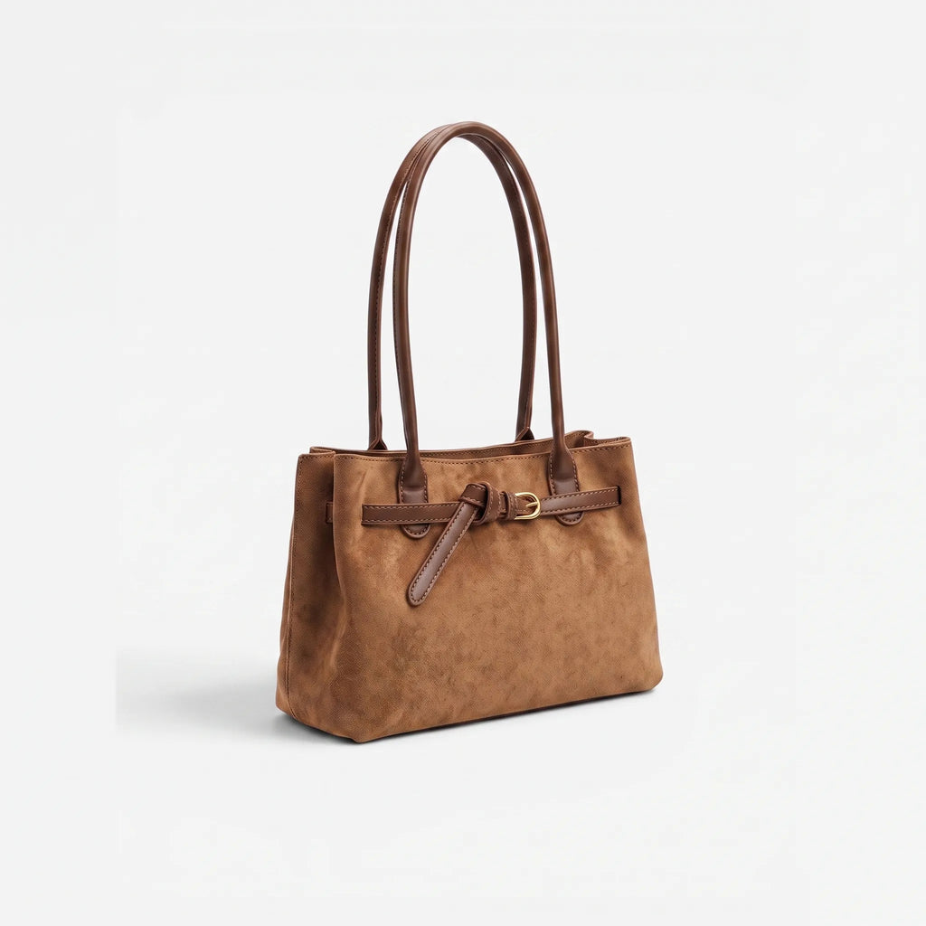 Structured women's tote bag with dual handles and front belt buckle detail