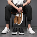 Textured slip-on loafers with rounded toes and flat contrasting soles