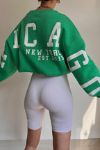 Women's crewneck sweatshirt with bold letter graphics on the long sleeves