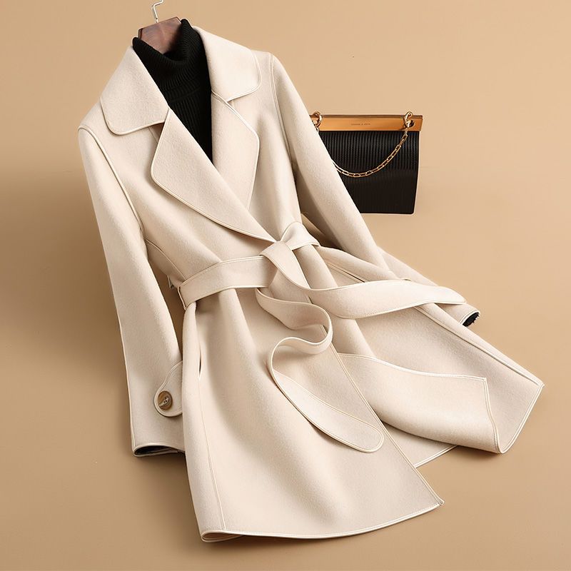 Women's longline belted trench coat with wide lapels and contrast edging