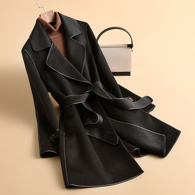 Women's longline belted trench coat with wide lapels and contrast edging