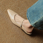 Women's pointed ballet flats with buckle straps and low heels