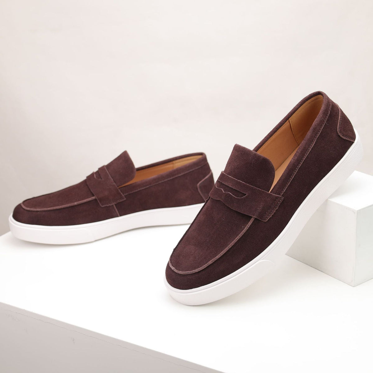 Men's textured penny loafers with rounded toes and white flat soles