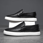 Textured slip-on loafers with rounded toes and flat contrasting soles