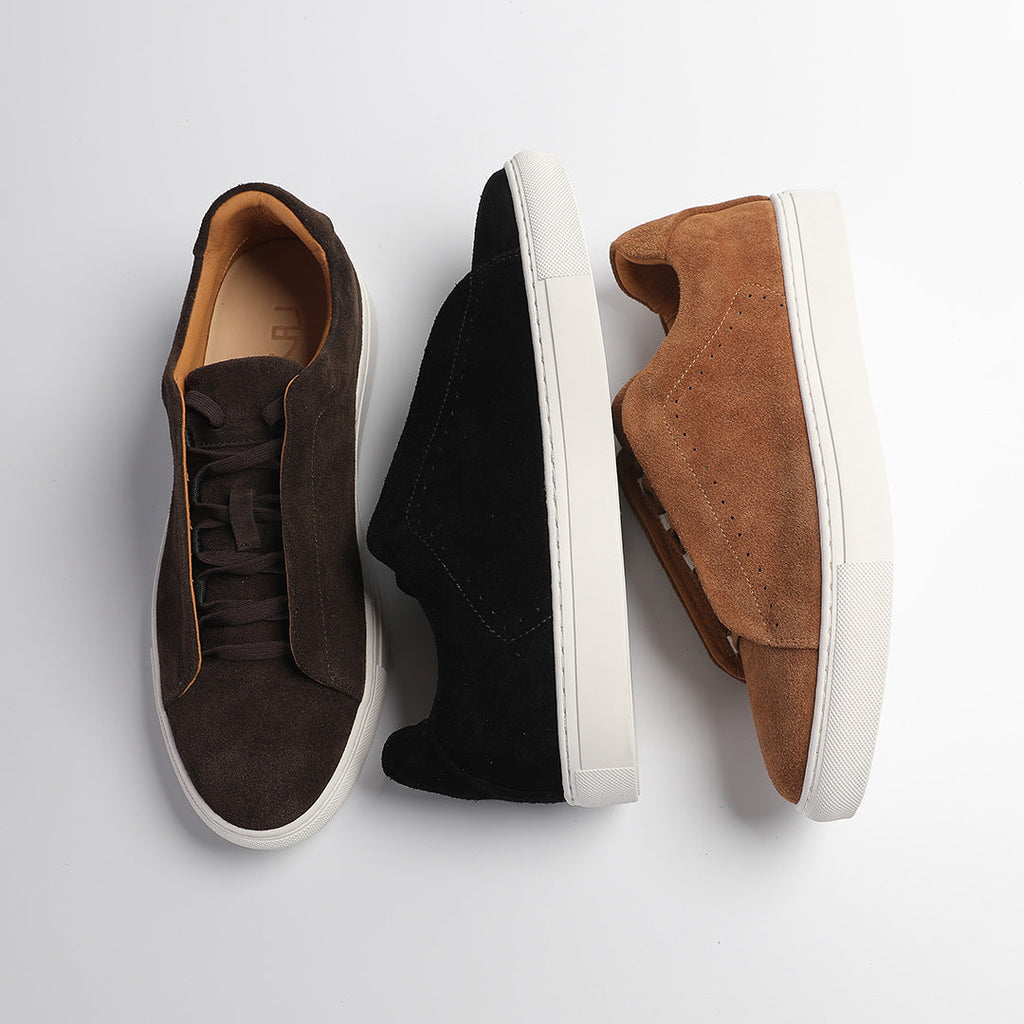 Low-top lace-up trainer with perforated side detailing and contrasting white sole