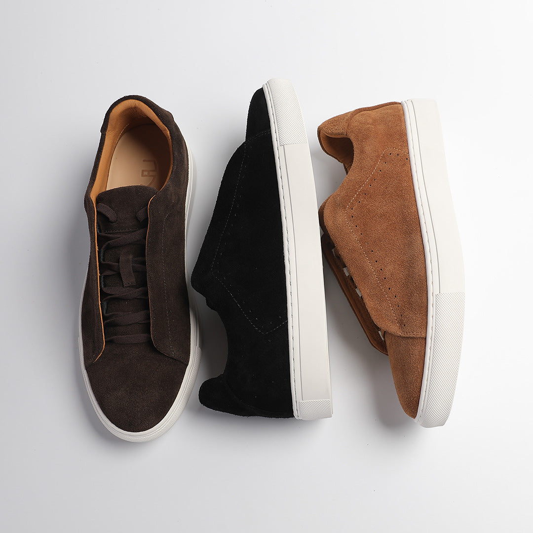 Low-top lace-up trainer with perforated side detailing and contrasting white sole