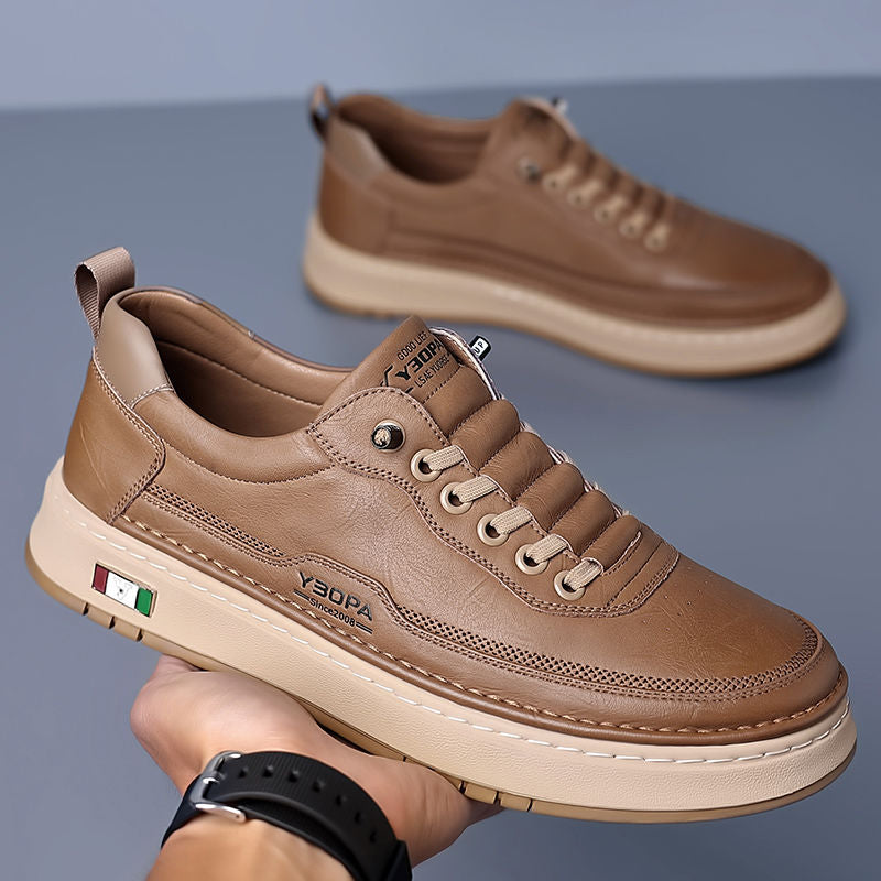 Low-top lace-up trainer with panelled upper, round toe and flat textured sole