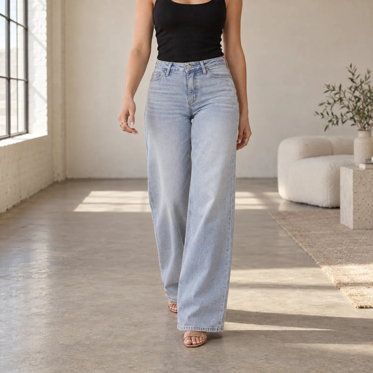 Women's light washed wide leg jeans with a mid-rise waist and five-pocket design