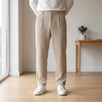 Men's textured pleated trousers with an elasticated waistband and straight legs