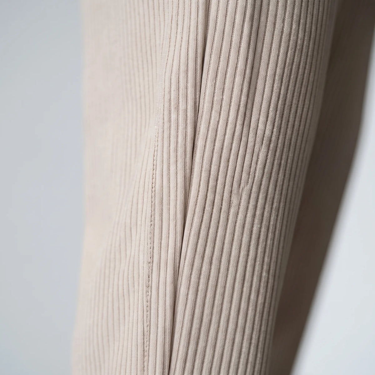 Men's textured pleated trousers with an elasticated waistband and straight legs