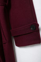 Women's burgundy long belted trench coat with double-breasted buttons and lapels