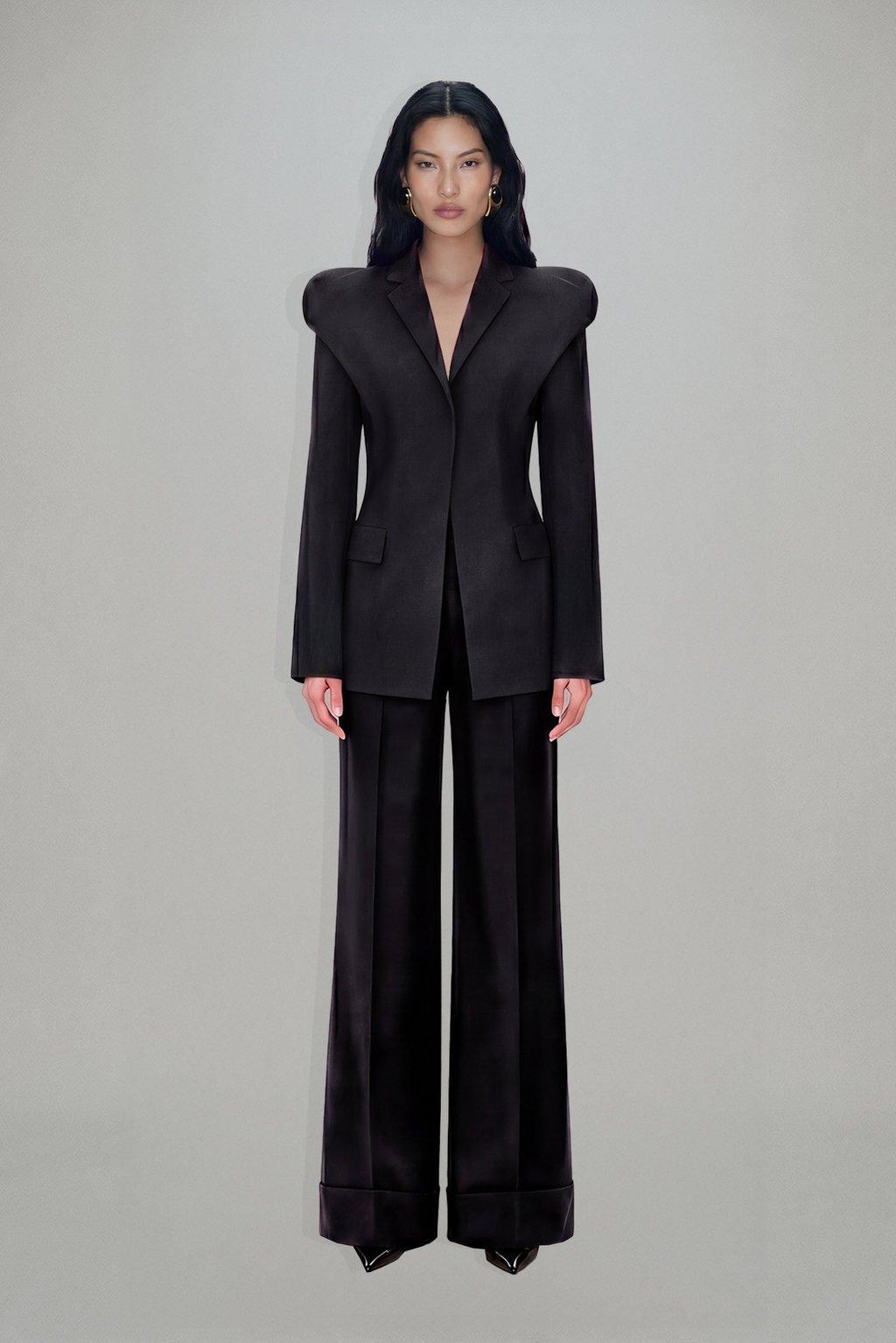 Women's charcoal fitted blazer with structured shoulders and peak lapels