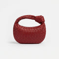 Woven handbag with braided knot handle and curved hobo shape