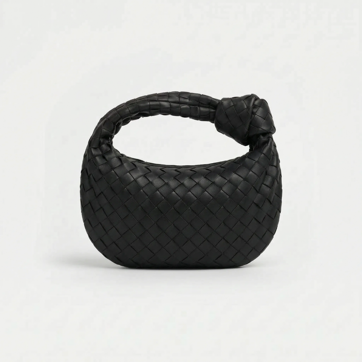 Woven handbag with braided knot handle and curved hobo shape