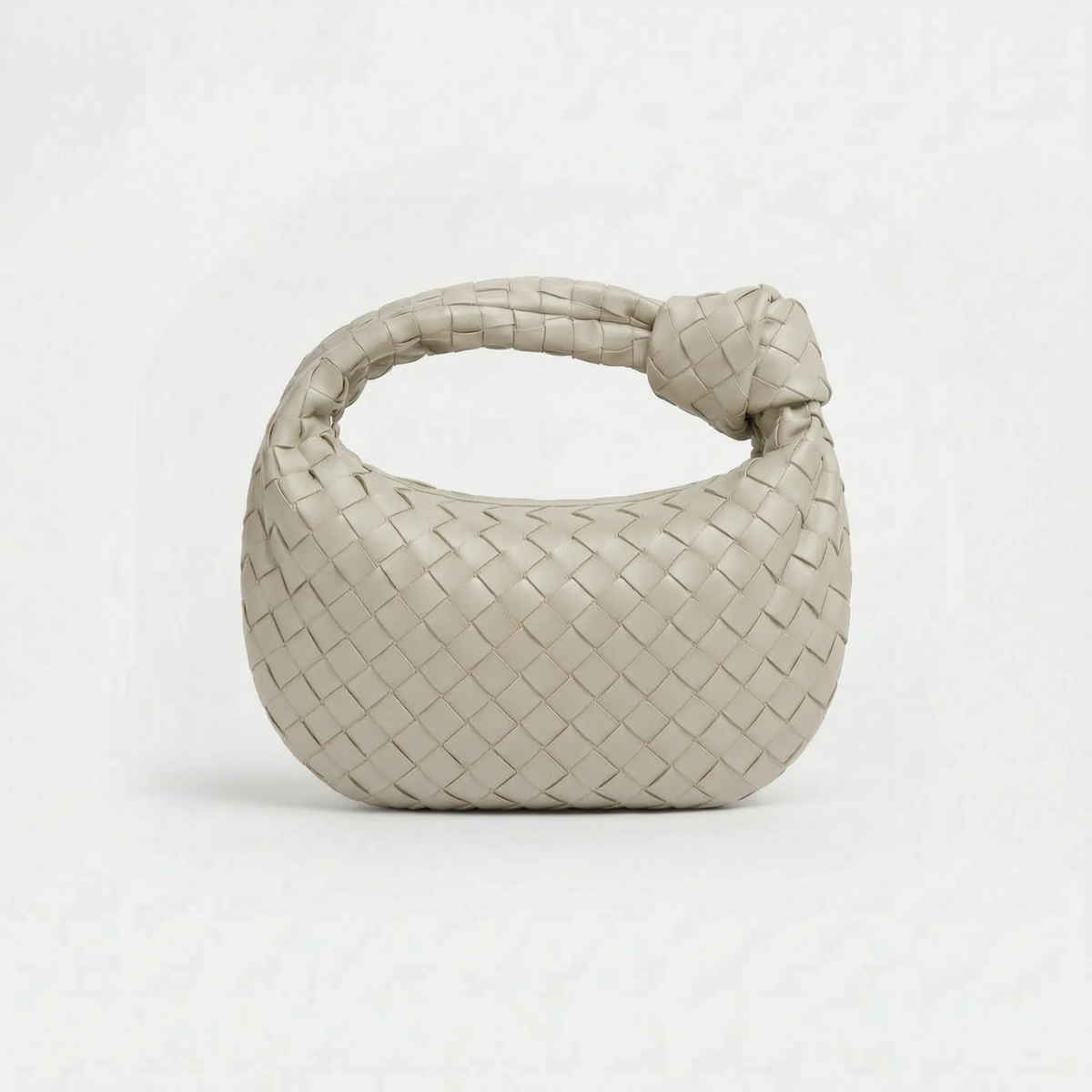 Woven handbag with braided knot handle and curved hobo shape