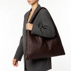 Oversized woven shoulder tote bag with a slouchy shape