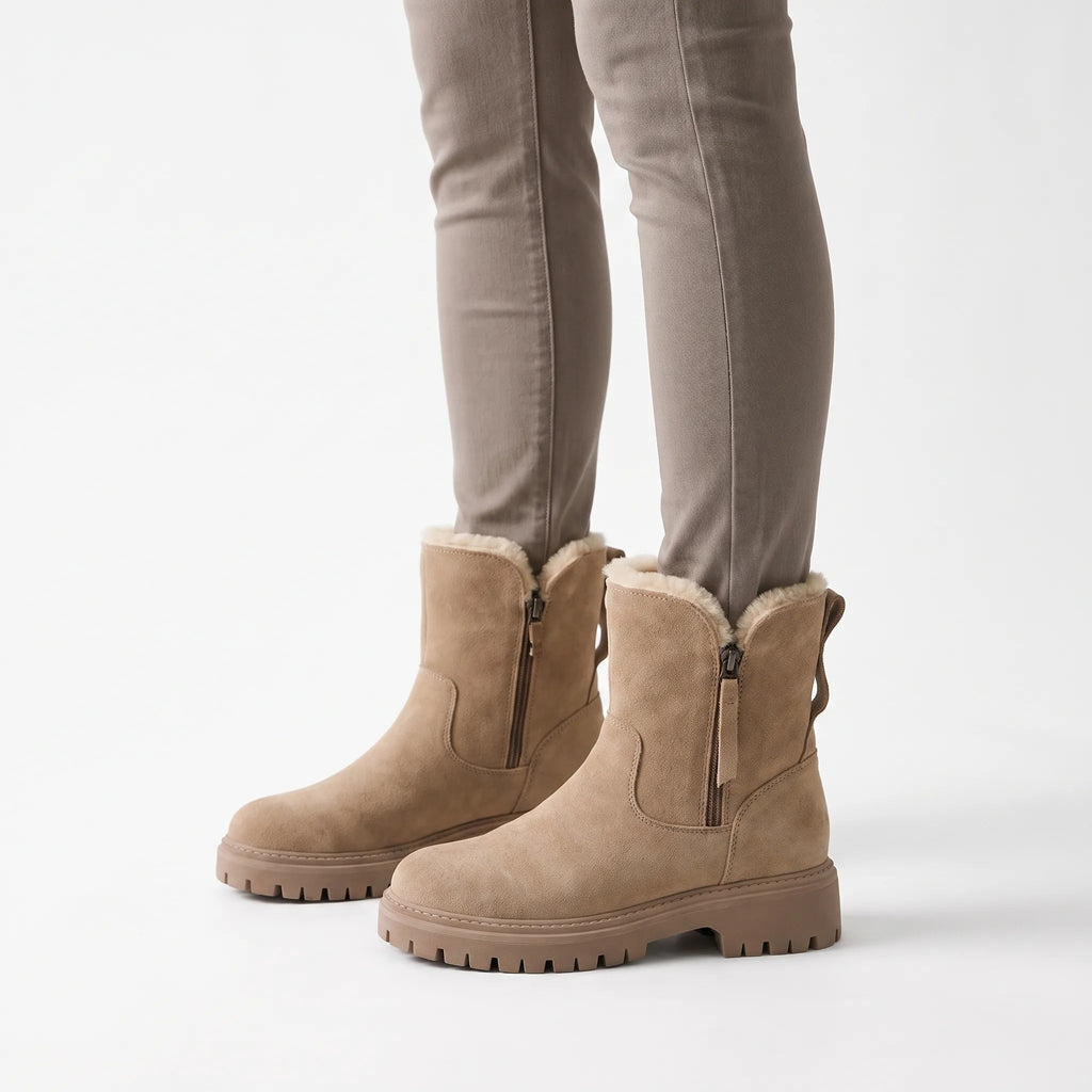 Lined chunky ankle boots with side zips, fur-like trim and lug soles shown in black and beige