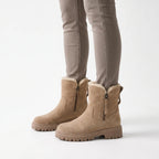 Lined chunky ankle boots with side zips, fur-like trim and lug soles shown in black and beige