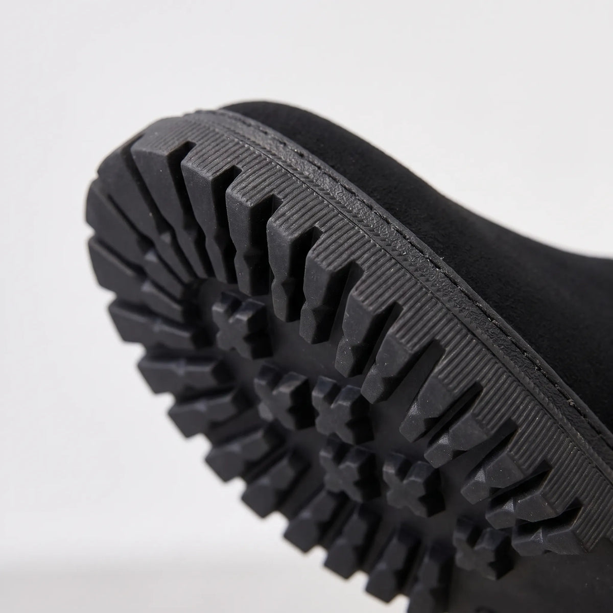 Lined chunky ankle boots with side zips, fur-like trim and lug soles shown in black and beige