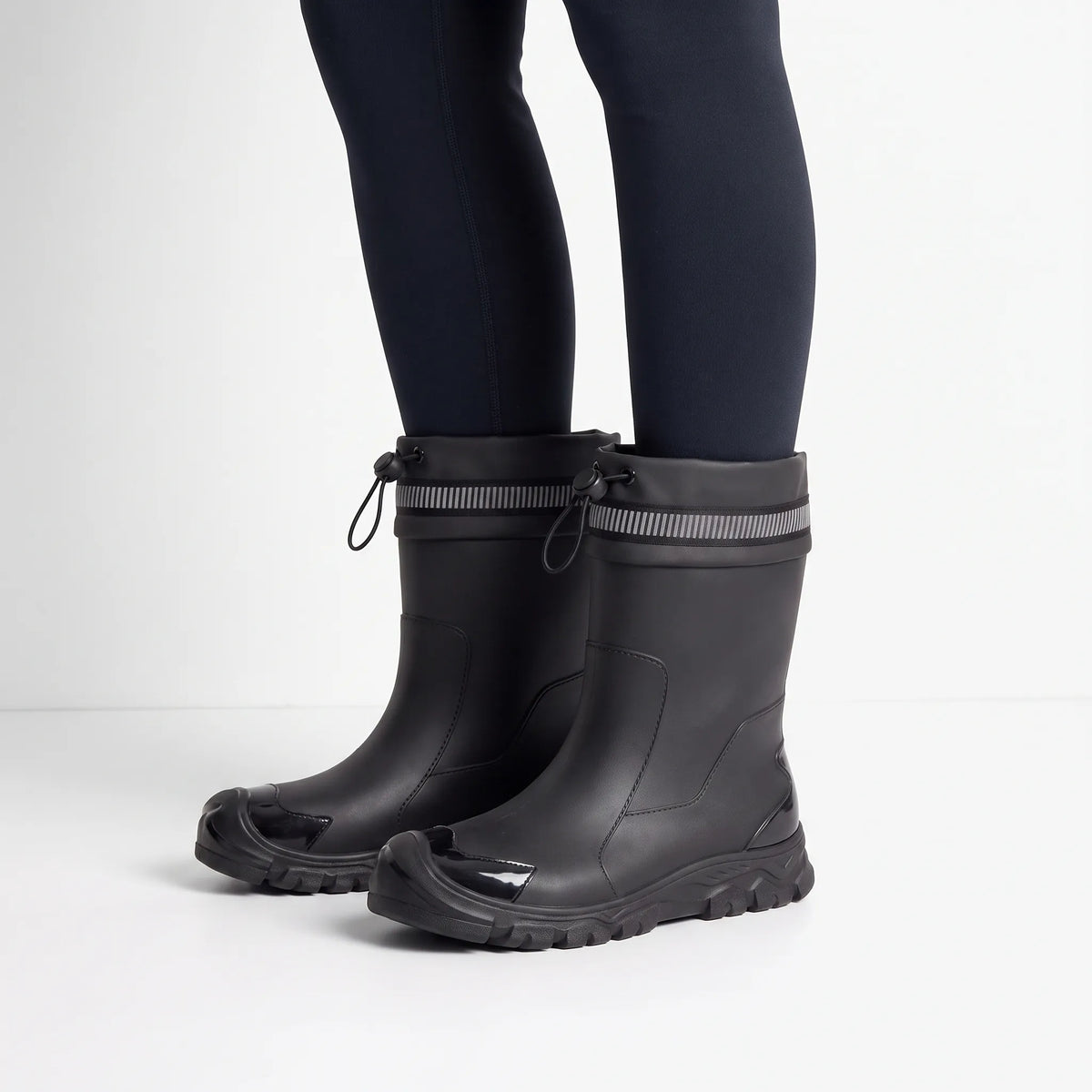 Mid-calf Wellington boots with drawstring collars and lugged soles