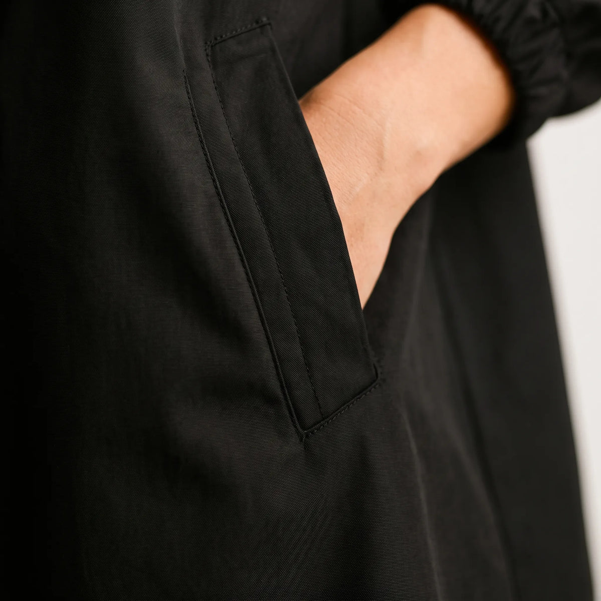 Women's long hooded waterproof coat with button front and pockets