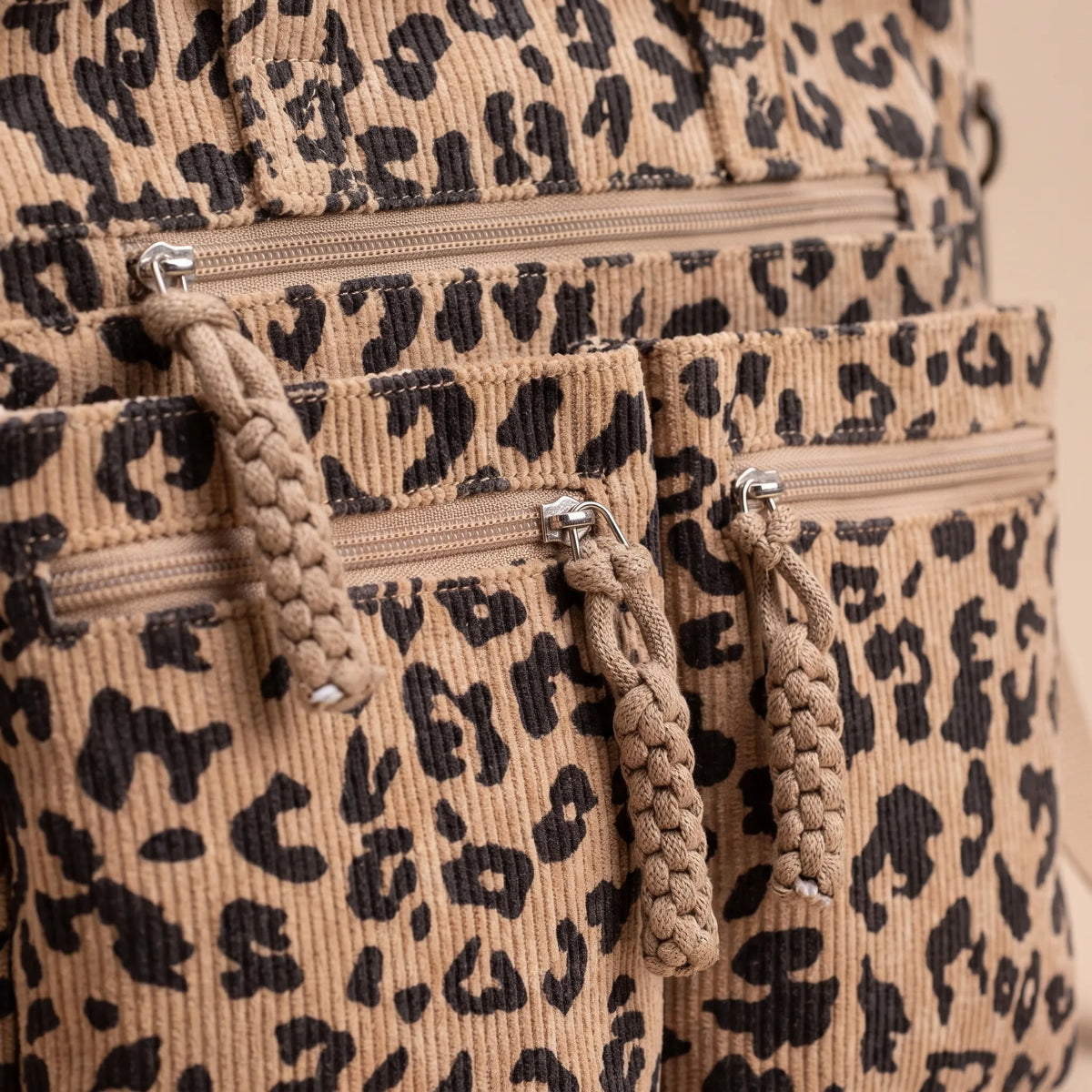 Women's ribbed leopard print tote bag with multiple front pockets and shoulder strap
