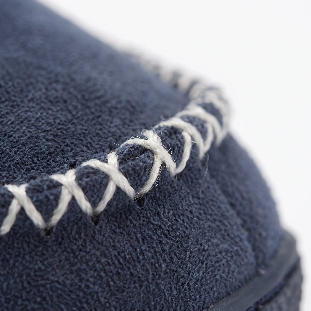 Women's cushioned slip-on house slippers with ribbed collars and stitched trim
