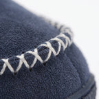 Women's cushioned slip-on house slippers with ribbed collars and stitched trim