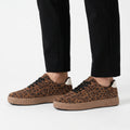 Women's low-top trainers with leopard print uppers, black laces and raised platform soles
