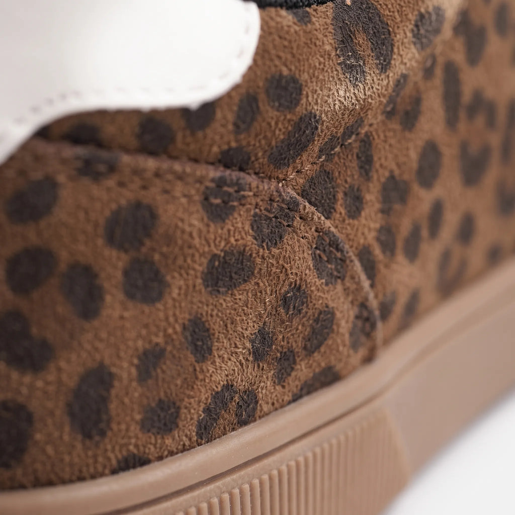 Women's low-top trainers with leopard print uppers, black laces and raised platform soles