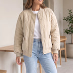 Women's oversized quilted bomber jacket with ribbed trim and front pockets