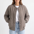 Women's oversized quilted bomber jacket with ribbed trim and front pockets