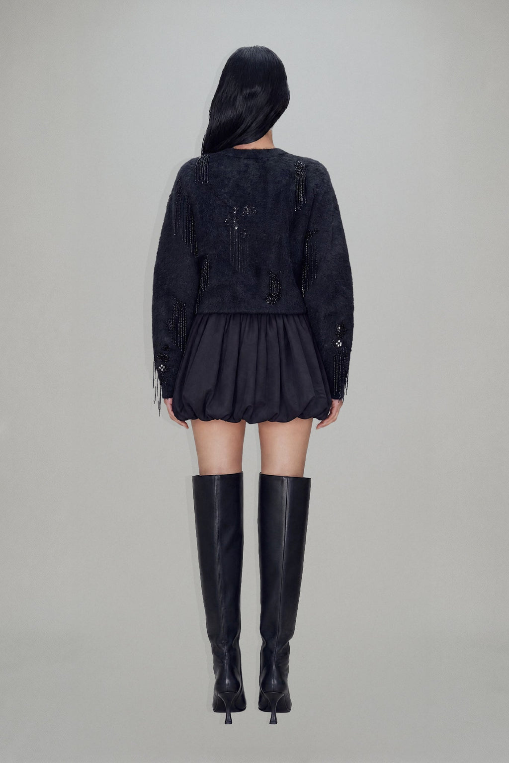 Women's black cropped blazer with V-neckline, long sleeves, embellishment and fringe trims