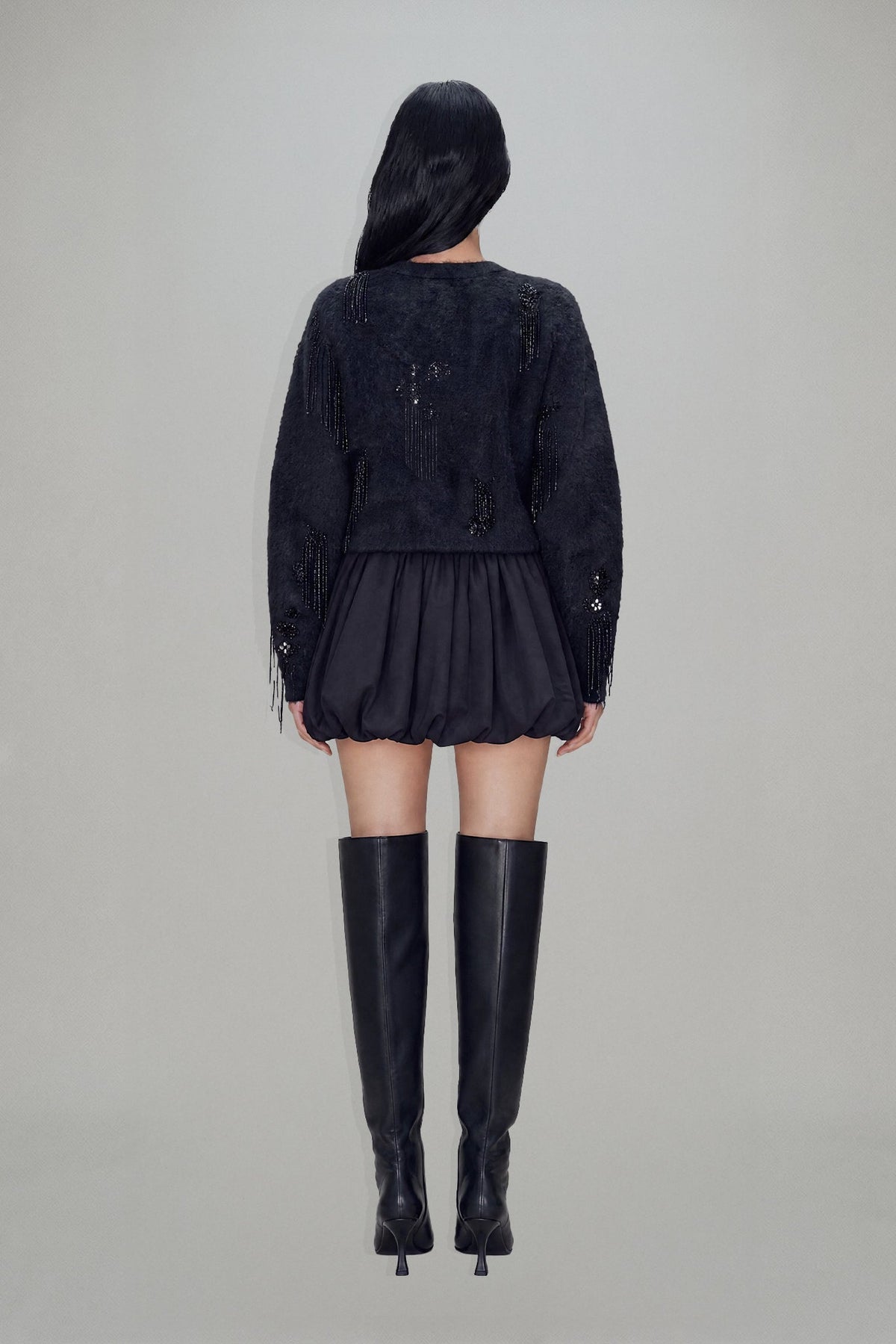 Women's black cropped blazer with V-neckline, long sleeves, embellishment and fringe trims