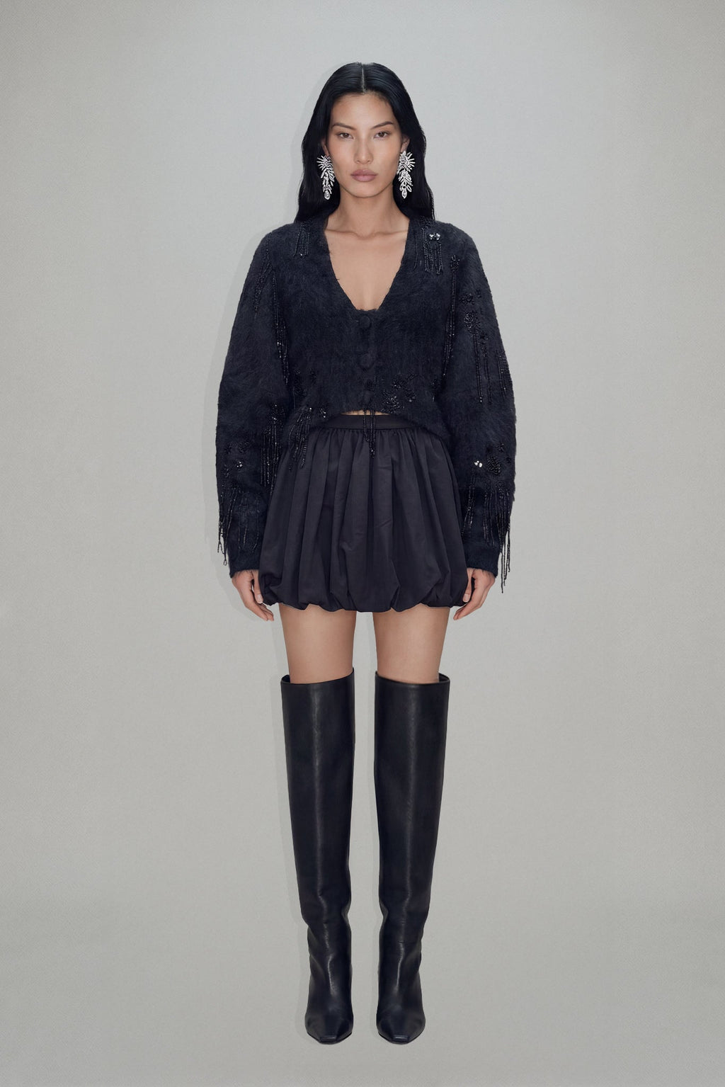 Women's black cropped blazer with V-neckline, long sleeves, embellishment and fringe trims