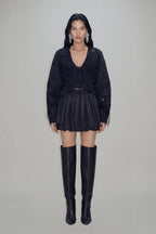 Women's black cropped blazer with V-neckline, long sleeves, embellishment and fringe trims