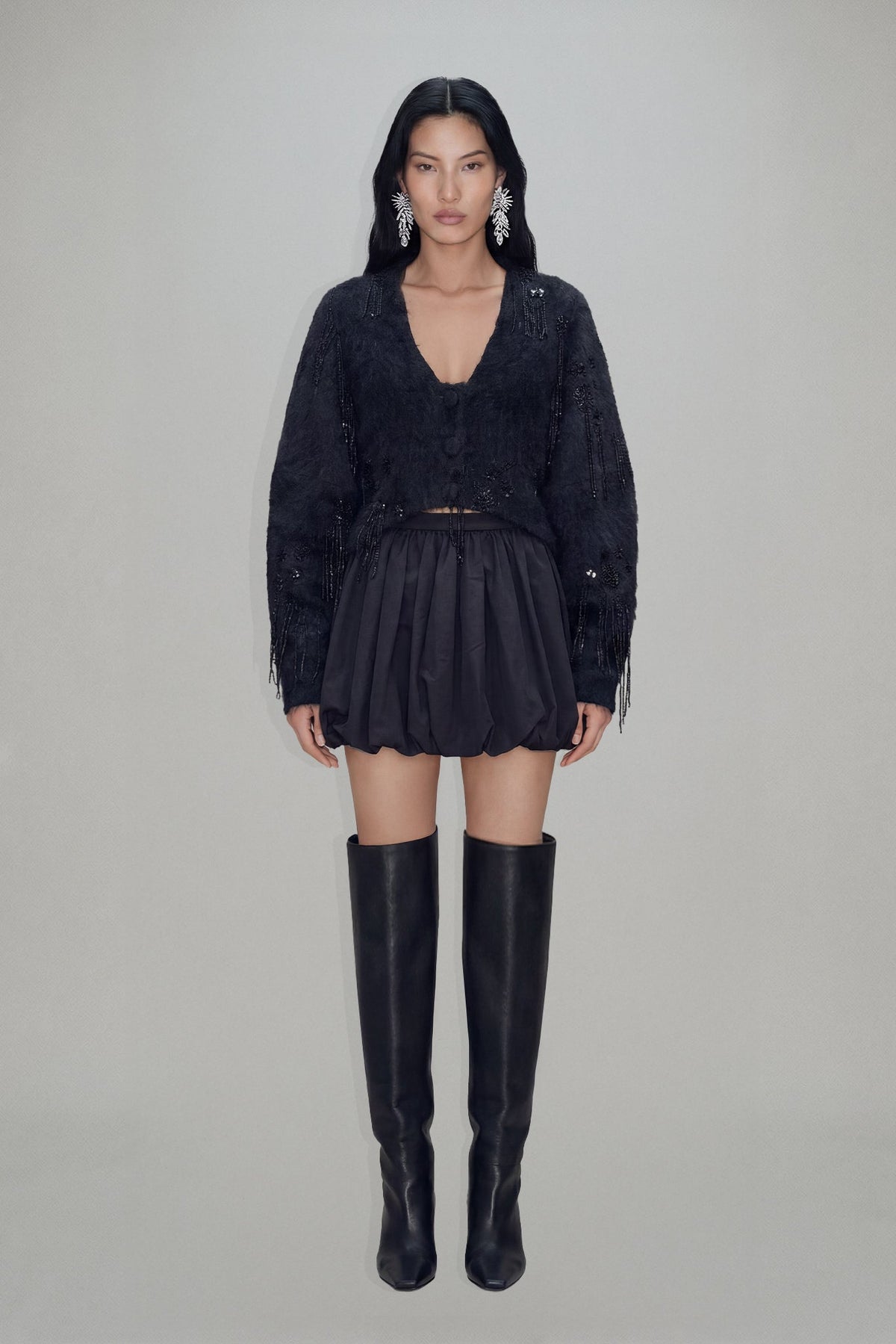 Women's black cropped blazer with V-neckline, long sleeves, embellishment and fringe trims
