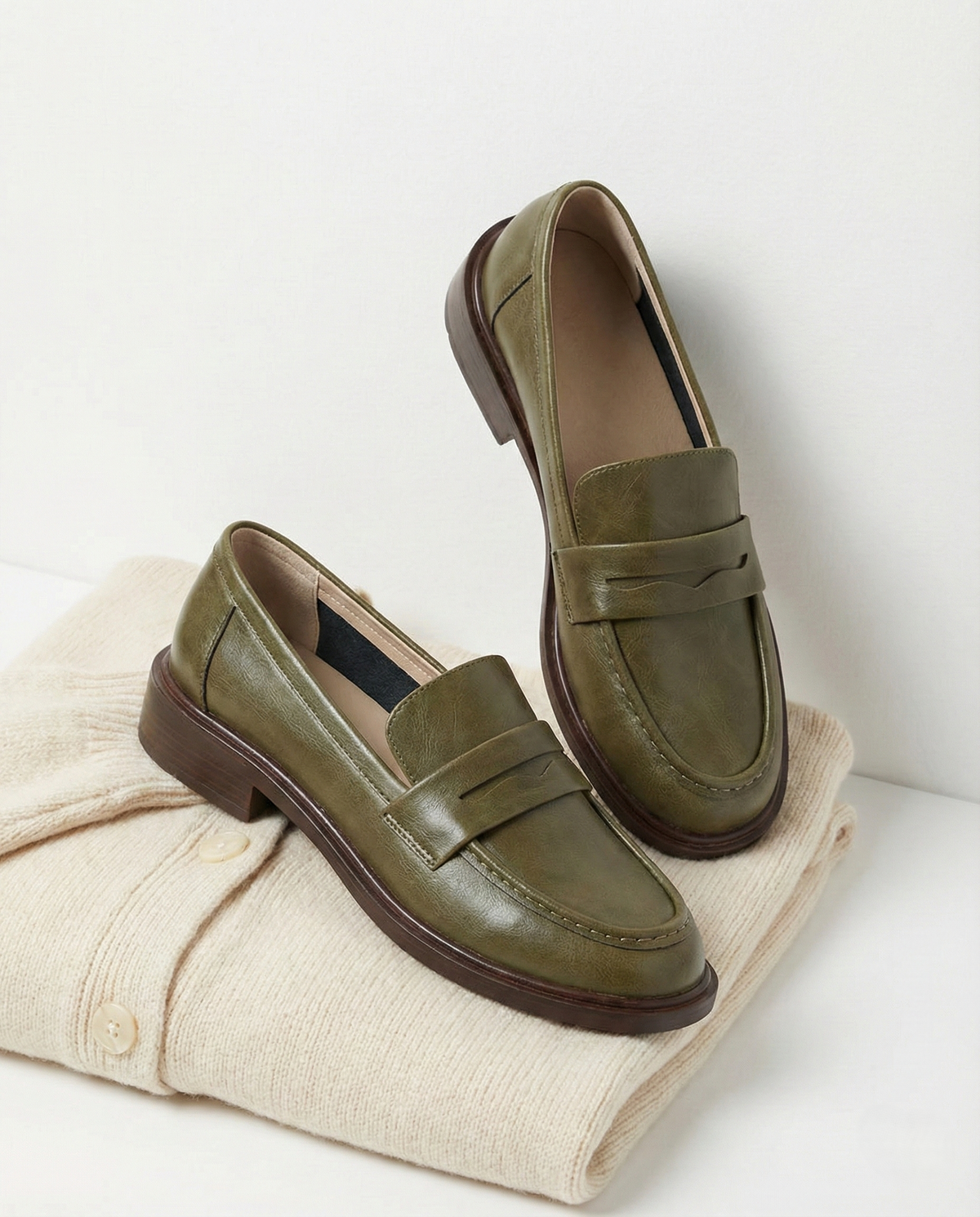 Women's slip-on loafers with penny straps, rounded toes and low heels