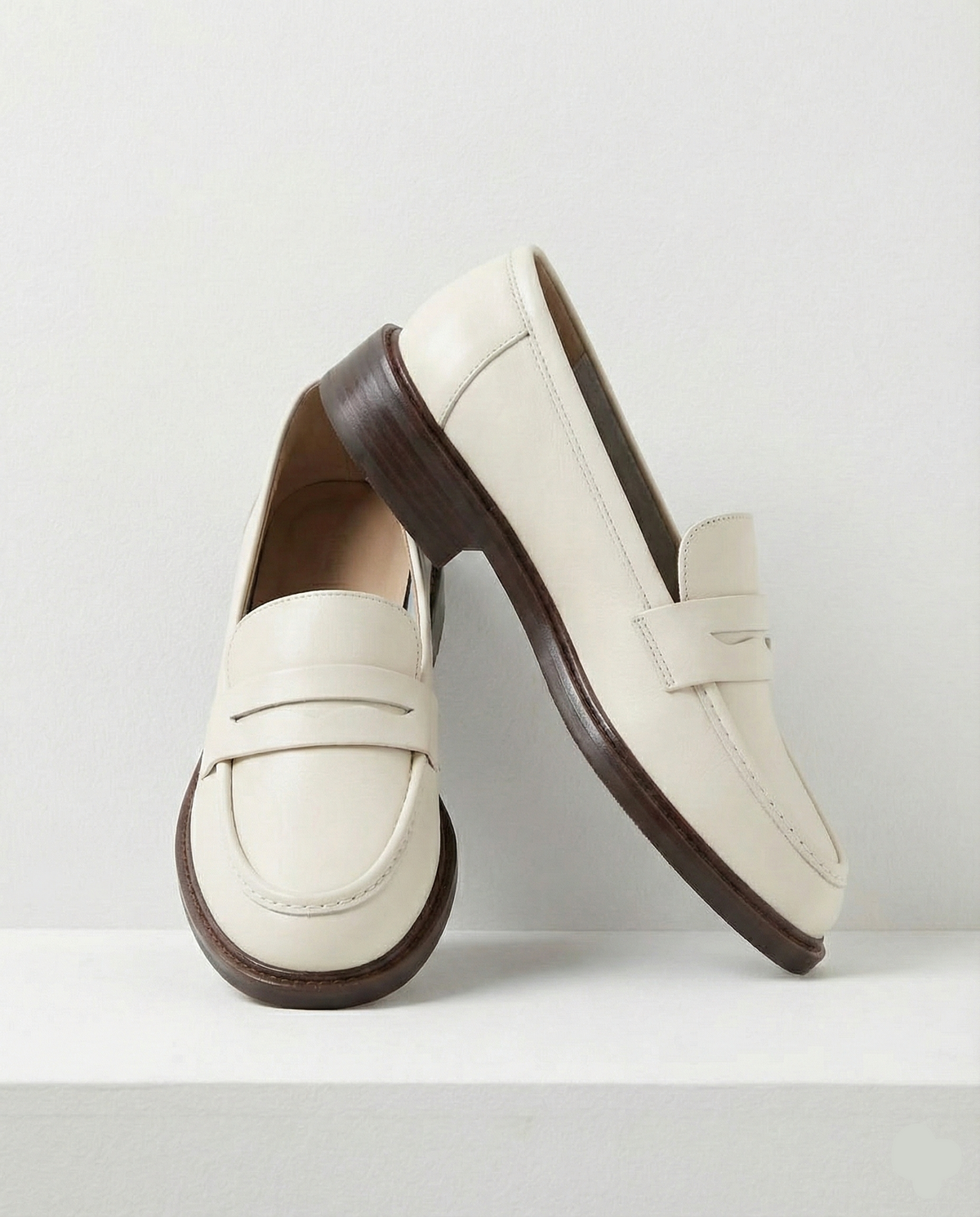 Women's slip-on loafers with penny straps, rounded toes and low heels