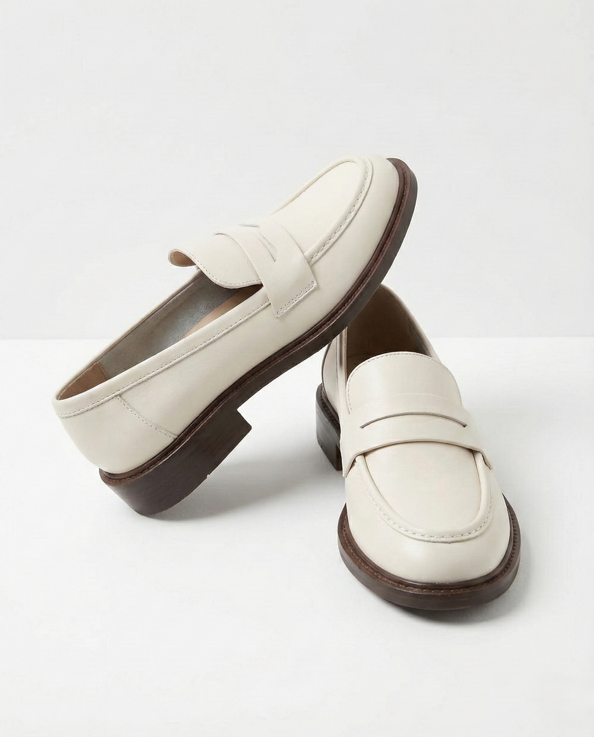 Women's slip-on loafers with penny straps, rounded toes and low heels